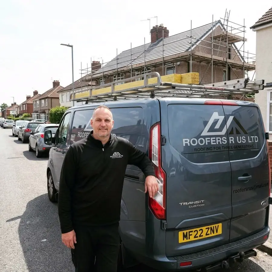 Dave from Roofers R Us Ltd standing beside the sign-written company van, with a scaffolded re-roof behind him