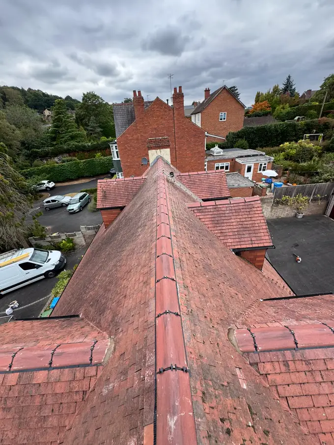 Ridge line of a traditional clay tiled roof with the street below