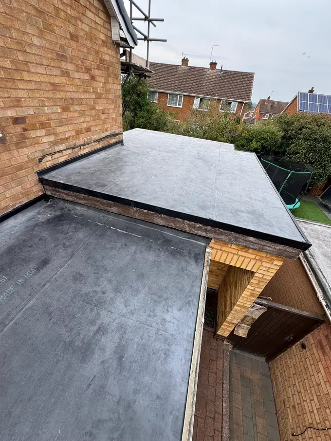 Repointed brick chimney stack with lead flashing on a red tiled roof